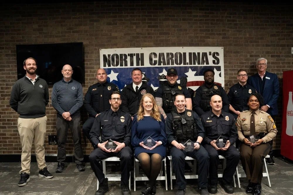 Group of uniformed public safety personnel and community members
